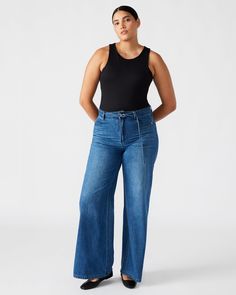 Effortlessly elevate your wardrobe with the SERENITY jeans. These jeans offer style and comfort, featuring a wide-leg design and self-belt. Embrace the on-trend look while effortlessly cinching your waist for a flattering silhouette. Crafted with denim for a lasting addition to your wardrobe. Wide-leg jeans with self-belt 80% cotton 15% polyester 5% rayon Inseam: 31.5" Hand wash Stephanie is 5ft 10in and is wearing a size 31 Lilia is 5ft 9in and is wearing a size 27 Imported Everyday Outfit, Leg Design, Bottom Clothes, Denim Fabric, Wide Leg Jeans, Everyday Outfits, Leg Jeans, Wide Leg, Women Jeans