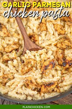 garlic parmesan chicken pasta in a skillet with a wooden spoon on the side