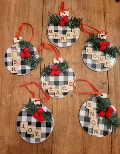 four christmas ornaments made from scrabbles with words on them