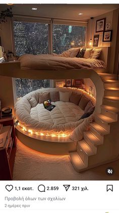 two beds with lights on them in the middle of a room next to a window