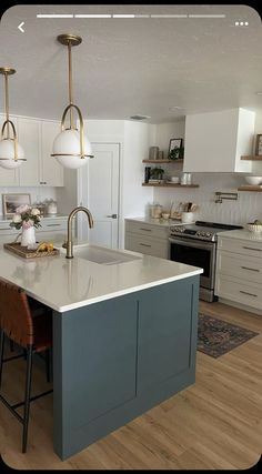 a kitchen with an island and two pendant lights