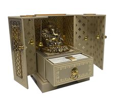 an intricately designed box with a buddha statue in the middle and gold trimmings