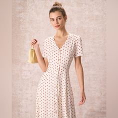 Details: - A-Line - Natural Waisted - Midi & Mid Calf - Slim Fit - No Stretch - 100% Polyester - Machine Wash Or Professional Dry This Polka Dot Midi Dress Is A Perfect Choice For Any Occasion. The Short Sleeves, Natural Waisted And Slim Fit Design Of The Dress Adds Movement And Flow, Making It Easy To Wear. The V-Neck, Button And Polka Dot Detail Adds A Feminine Touch And Makes This Dress Perfect For Any Occasion. Whether You're Going Out On A Date Or Attending A Formal Event, This Dress Is Sur Elegant Polka Dot Dresses With Buttons, Spring Polka Dot Dress With Button Closure, Polka Dot Knee-length Dress With Buttons, Polka Dot Dress With Button Closure For Spring, White Retro Dress With Button Closure, Polka Dot Button-up Spring Dresses, Polka Dot Knee-length Midi Dress For Daywear, Polka Dot Button-up Dress With Buttons, Polka Dot Button-up Dress