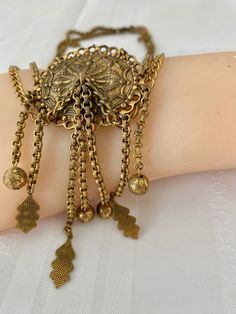 "Etruscan Revival Festoon Necklace and Bracelet Set Gold Tone Ornate Vintage Patina Necklace - 16.5\" plus festoon drop with dangles additional 4\" Length Bracelet - 7.5\" Bracelet medallion 1.76x x 1.50@ No markings Aged patina, can use white vinegar to brighten if preferred" Antique Bracelet Jewelry For Festivals, Vintage Locket Jewelry For Festivals, Antique Gold Vintage Jewelry For Festivals, Vintage Antique Gold Jewelry For Festivals, Bohemian Gold Jewelry With Historical Design, Antique Gold Jewelry For Festivals, Decorative Vintage Jewelry For Festivals, Vintage Decorative Jewelry For Festivals, Metal Bracelets With Latkans For Festival