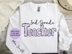 An adorable sweatshirt or t-shirt for the 3rd/third grade teacher. Customize by adding a name on the sleeve.  Great to wear while teaching.  SWEATSHIRT PRODUCT DESCRIPTION: Ideal for any situation, a unisex heavy blend crewneck sweatshirt is pure comfort. These garments are made from polyester and cotton. This combination helps designs come out looking fresh and beautiful. The collar is ribbed knit, so it retains its shape even after washing. There are no itchy side seams on these sweaters.  * Personalized Crew Neck Tops For Back To School, School Long Sleeve T-shirt With Name Print, Long Sleeve White T-shirt For Teacher Appreciation, Long Sleeve Cotton Top For School Events, Customizable Long Sleeve T-shirt For School Spirit, Long Sleeve Cotton Tops For School, Cotton Long Sleeve Tops For School Events, White Long Sleeve Tops For Back To School, Long Sleeve Tops For End Of School Year Events