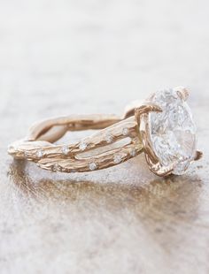 a close up of a ring with a diamond in it on top of a table