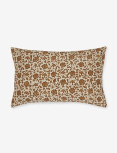 a brown and white pillow with an animal print pattern on the front, sitting on a gray background