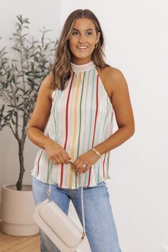 Our Plisse Multi Stripe Pleated Top is crafted with lightweight plisse fabric, featuring vibrant multi-colored stripes that add a pop of color and personality to any outfit! With its relaxed fit and airy feel, it's perfect for warm weather days or layering under a cardigan or jacket when the temperature drops. Pair it with jeans or shorts for a casual and effortless ensemble, or dress it up with tailored trousers or a skirt for a more polished look. Spring V-neck Top With Pleated Sleeves, Multicolor Pleated A-line Midi Dress, Spring Pleated Button-up Tops, Pleated A-line Multicolor Midi Dress, Multicolor Pleated V-neck Maxi Dress, Plisse Fabric, Pleat Top, Tailored Trousers, Polished Look