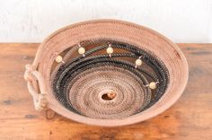 a woven basket sitting on top of a wooden table