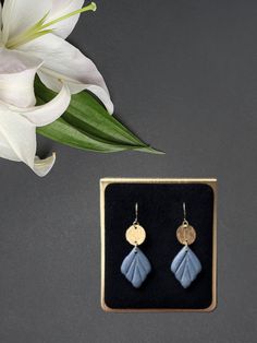 Get your fall glam on with our Small Shimmery Dangle earrings! Made of shimmery polymer clay and 18k gold plated hooks that won't irritate sensitive ears. Each pair comes with a brass charm for added flair and multiple color options to match any fall outfit. Upgrade your style with these simple yet stylish dangles. Blue Drop Earrings In 14k Gold Filled, Handmade 14k Gold Filled Blue Earrings, Blue 14k Gold Filled Earrings, Blue 14k Gold Filled Drop Earrings, Handmade Blue 14k Gold Filled Earrings, Hypoallergenic Gold Polymer Clay Jewelry, Artsy Blue Dangle Earrings, Blue 14k Gold Filled Dangle Earrings, Elegant Blue Polymer Clay Earrings