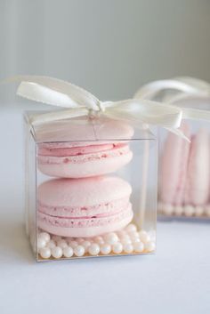 pink macaroons in a clear box with pearls