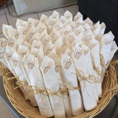 a basket filled with white paper bags on top of a table