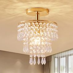 a chandelier hanging from the ceiling in a living room