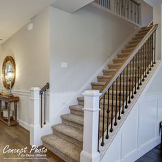 a staircase leading up to the second floor in a house with white walls and wood floors