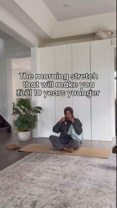 a woman sitting on top of a yoga mat next to a potted plant with the words, the morning stretch that will make you feel 10 years younger