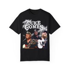 a black t - shirt with an image of two men playing guitars and the words luke go