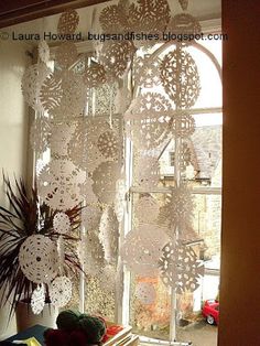 the window is decorated with white paper doily