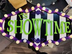 a sign that says it's showtime with lights