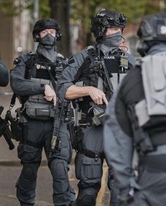 police officers in full riot gear standing on the street