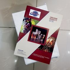 the brochure is on top of two envelopes with wine bottles and grapes in them