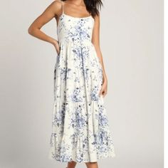 You'll Be Ready To Wander The Whitewashed Streets And Sunny Beaches Of A Romantic Island In The Lulus Mykonos Mood Ivory Floral Print Tie-Strap Tiered Midi Dress! Lightweight Woven Fabric, Decorated With A Summery Blue Floral Print, Falls From Adjustable Spaghetti Straps To Support A Darted Bodice With A Drawstring Tie At The Back. The High Waist Tops A Tiered Skirt That Falls To A Midi Hem. Elastic At Back For Fit. Pair With Your Favorite Espadrilles For A Perfect Look! Unlined. 55% Linen 45% R White Sundress With Adjustable Straps For Garden Party, White Maxi Dress With Adjustable Straps For Garden Party, White Maxi Dress With Adjustable Straps For Brunch, Casual White Maxi Dress With Adjustable Straps, White Midi Sundress With Adjustable Straps, White Dress With Adjustable Straps For Daytime, White Sundress Midi Dress With Adjustable Straps, White Flowy Dress With Adjustable Straps, Casual White Midi Dress With Adjustable Straps