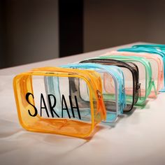 four small clear bags with the word sarah written on them sitting on a table