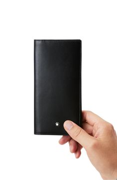 A geometric design enhances the distinctive style of a smooth leather wallet embellished with logo hardware. 3.3"W x 6.8"H x 0.5"D Interior currency pocket; 15 card slots Leather Made in Italy Modern Black Card Holder For Formal Use, Modern Black Card Holder For Formal Occasions, Modern Black Formal Card Holder, Modern Formal Wallets, Designer Trifold Wallets For Formal Occasions, Designer Rfid Blocking Wallet For Formal Occasions, Black Leather Wallet, Black Wallet, Passport Holder