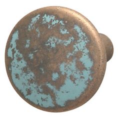 an old, rusted metal knob with blue paint on it and the colors are different