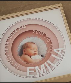 a baby's birth announcement is displayed in a frame with the name ema on it