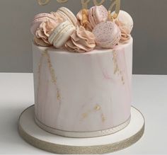 there is a cake with pink and gold decorations on the top that says happy birthday