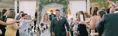 a bride and groom walking down the aisle after their wedding ceremony with guests throwing confetti on them