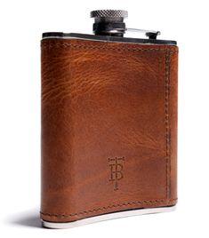 a brown leather flask with the initials tb on it