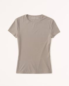 Women's Soft Matte Seamless Tuckable Baby Tee | Women's Tops | Abercrombie.com Seamless Second-skin Short Sleeve Tops, Casual Second-skin Short Sleeve Top, Solid Short Sleeve Seamless Stretch Top, Stretch Seamless Solid Short Sleeve Top, Solid Stretch Seamless Short Sleeve Top, Compressive Solid Color Crew Neck T-shirt, Seamless Short Sleeve T-shirt For Athleisure, Seamless Short Sleeve T-shirt With Minimal Stretch, Compressive Crew Neck T-shirt