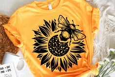 a sunflower with a bee on it sitting next to a basket and some flowers