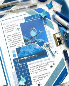 a blue and white scrapbook spread with pens, scissors, markers, and other items