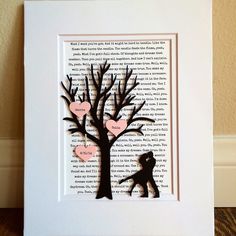 a paper cut out of a tree with hearts hanging from it's branches and the silhouette