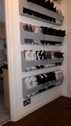 there are many pairs of shoes hanging on the wall