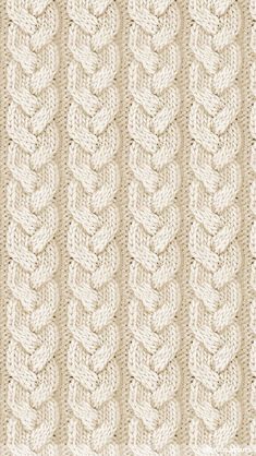 a knitted blanket with braiding on the bottom and sides, in beige tones