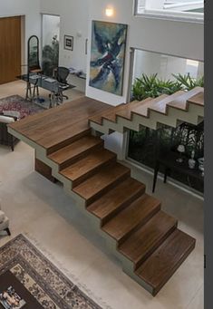 a living room filled with furniture and stairs