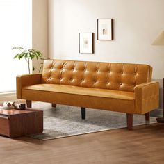 a living room with a couch, coffee table and lamp