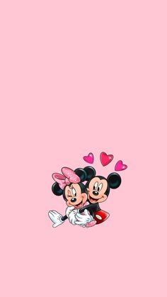 two mickey and minnie mouses with hearts flying above them on a pink wallpaper background