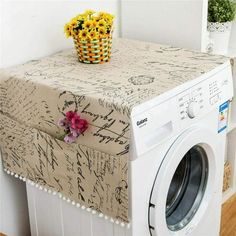 a white washer sitting next to a dryer on top of a wooden floor