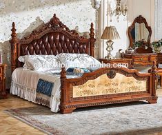 an ornate wooden bed frame in a bedroom