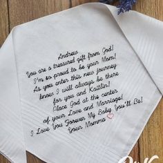 two white napkins with embroidered poem on them