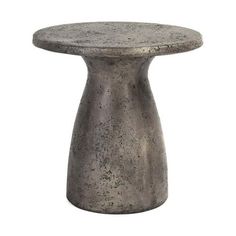 a small table with a round top on a white background, it is made out of concrete