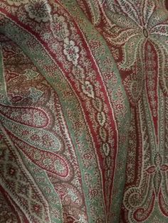 the fabric is red and green with paisley patterns