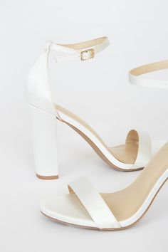 Lulus Exclusive! No one does it quite like the Lulus Taylor Ivory Satin Ankle Strap Heels! Whether you choose to dress them up or down, these sleek, satin single sole heels will stun with their slender toe strap, and adjustable ankle strap (with a gold buckle). 4" wrapped block heel. Cushioned insole. Nonskid rubber sole. Man made materials. Imported. Lulus | Taylor Ivory Satin Ankle Strap Heels | Size 8. Fitted Satin Open Toe Heels, White Satin Ankle Strap Heels, Satin Open Toe Heels With 4-inch Heel, White Satin High Heels, Satin High Heels With Padded Heel, Satin Heels With Padded Heel And Round Toe, Single Sole Heels, Dance Ideas, Wedding Pumps