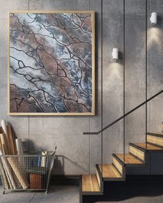 a painting hanging on the wall next to some stairs