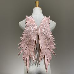 the back of a mannequin with pink wings on it