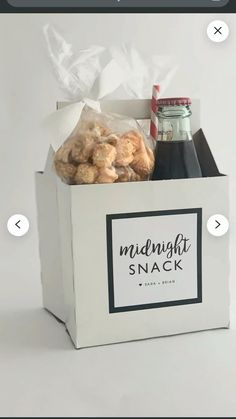 a white box filled with food and drinks on top of a white tablecloth covered floor